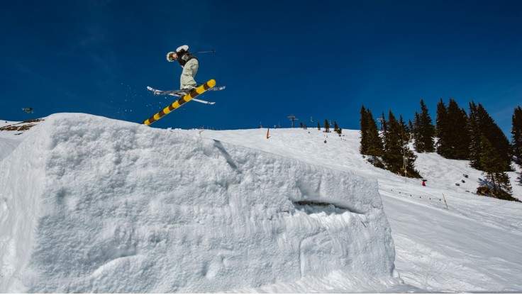 Snowboarder sitting on a bench