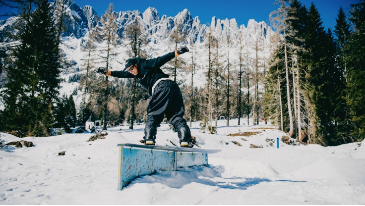 Snowboarder makes a backside air